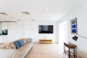 a living room with a couch and a tv at 2 Bed 2 Bath Penthouse With Amazing Views with Free Parking in London