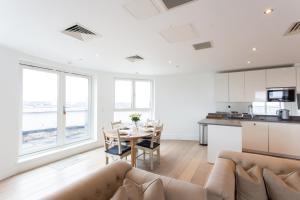 a living room with a couch and a table at 2 Bed 2 Bath Penthouse With Amazing Views with Free Parking in London +32 photos