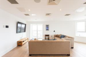 a living room with two couches and a table at 2 Bed 2 Bath Penthouse With Amazing Views with Free Parking in London