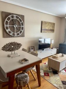 a living room with a large clock on the wall at APARTAMENTO FELECHOSA in Felechosa