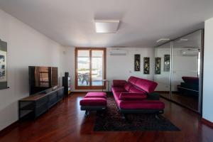 a living room with a red couch and a tv at Casa Andrew New in Rome