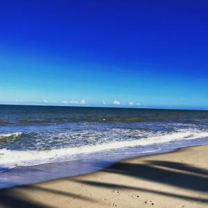 a shadow of a person on the beach at Casa Pau Brasil in Prado