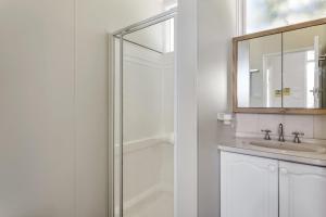 a bathroom with a shower and a sink and a mirror at Bethany Bay Mount Martha in Mount Martha