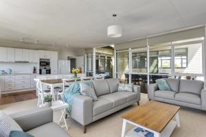a living room with a couch and a table at Bethany Bay Mount Martha in Mount Martha