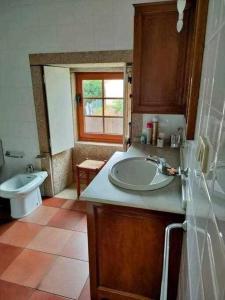 y baño con lavabo y aseo. en Casa Brisas del Mar, en Cabana de Bergantiños