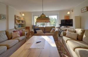 a living room with couches and a coffee table at Widokówka Karkonoska in Szklarska Poręba