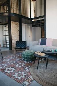 a living room with a couch and a table at Beautiful Bohemia apt in Jaffa in Tel Aviv