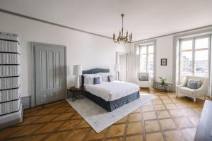 a bedroom with a bed and a chandelier at Château de l'Aile- Boutique Suites in Vevey
