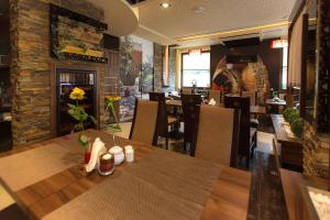 a dining room with a table and chairs in a restaurant at Willa Pod Bramą in Sandomierz