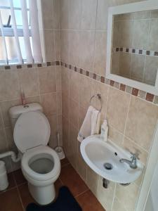 a bathroom with a toilet and a sink at Pearly Beach Fish Relax in Pearly Beach +12 photos