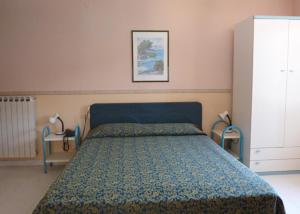 Säng eller sängar i ett rum på Hotel Miramare