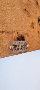a metal tag on a piece of wood at The Cornish Getaway in Newquay