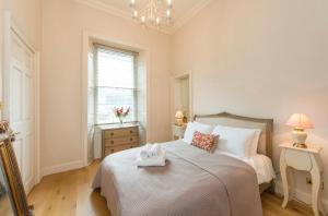 a bedroom with a bed with a towel on it at Luxurious city centre self catering apartment in Edinburgh