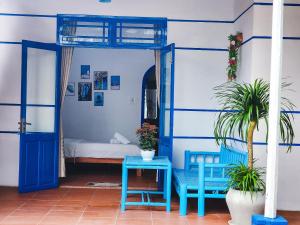 a room with a blue door and a bed at Dragon Sea Homestay in Hoi An