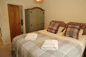 a bedroom with a bed with towels on it at Pheasant Walk at Eaton Manor in Church Stretton