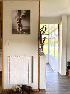 a hallway with a dog picture on the wall at Xilloi Playa in O Vicedo