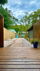 a wooden walkway with a wooden fence and trees at Casinha na Ilha do Mel - Pr in Ilha do Mel