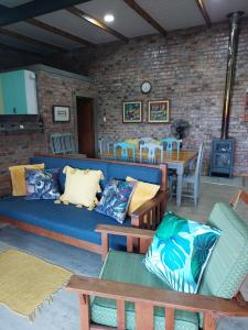 a living room with a blue couch and a table at RoamRooiberg in Robertson