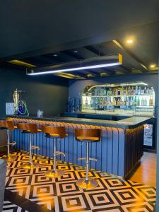 a bar with bar stools in a room at Vannasut Hotel and Spa in Kathmandu