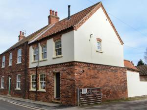 an old brick building on the corner of a street at Loyal Cerise in Cawood