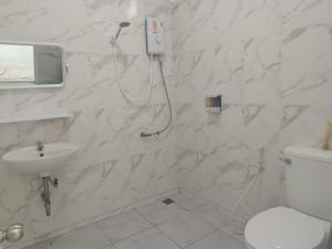 a white bathroom with a toilet and a sink at Ma Lay Resort in Ban Pheng Krong +37 photos