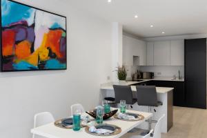 a kitchen and dining room with a table and chairs at Star London Station Road 3-Bed Oasis with Garden in The Hyde