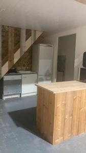 a kitchen with a counter and a refrigerator in a room at Grange Rousselin in Bachivillers