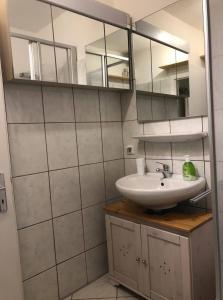 a bathroom with a sink and a mirror at Room in Apartment - Allgauer Festwoche 150m Entfernt in Kempten