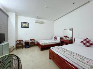 Säng eller sängar i ett rum på Nam A Hotel - Central City