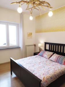 a bedroom with a large bed and two windows at Villa dei Fiori in Luino