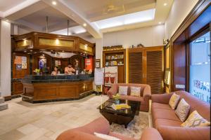 a lobby with couches and a bar in a restaurant at Zostel Delhi in New Delhi