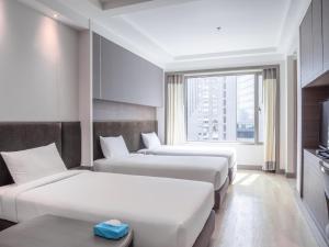 Postel nebo postele na pokoji v ubytování Jasmine City Hotel