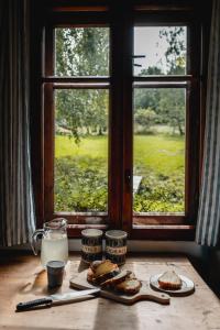 a table with two plates of food and a window at Dom Geologa in Marianówka