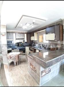 a large kitchen with a large island in the middle at زهرة مطروح للشقق الفندقية in Marsa Matruh