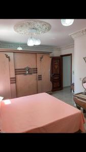 a bedroom with a pink bed and a piano at زهرة مطروح للشقق الفندقية in Marsa Matruh