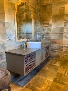 a bathroom with a sink and a mirror at Chivay Country Cottages in Rooiberg