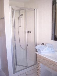 a shower with a glass door in a bathroom at Boddenzauber in Fuhlendorf