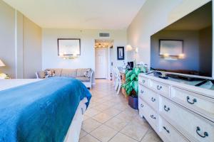 a large bedroom with a bed and a couch at Pirates Bay A402 in Fort Walton Beach