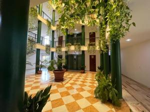 an empty lobby with plants in a building at Milenium Palace - Garaje incluido - Piscina-FIBES in Seville