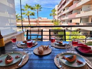 een blauwe tafel met borden eten op een balkon bij Apartment Theresa Los Gigantes in Puerto de Santiago