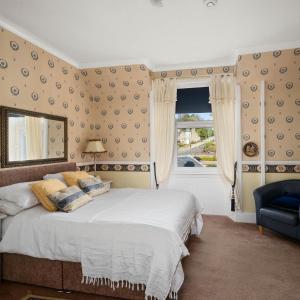 a bedroom with a large bed and a window at Ashley House in Dundee