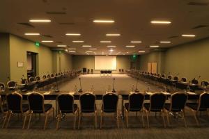 a conference room with a long table and chairs at Pine Astoria Hotel in Tbilisi City