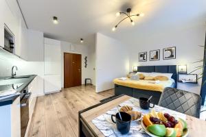 ワルシャワにあるKaZou Residenceのキッチン、ベッド1台が備わる小さなアパートメントです。