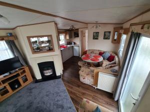 an aerial view of a living room and kitchen in a caravan at 92 Barmouth Bay Holiday Park in Llanddwywe