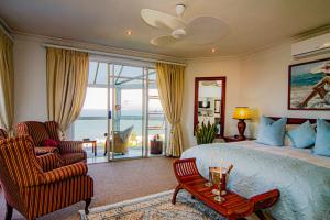 a bedroom with a bed and a view of the ocean at Burnham House B&B in Durban