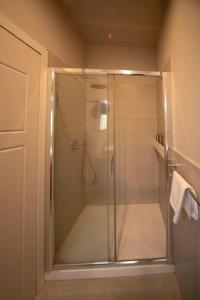 La salle de bains est pourvue d'une douche avec une porte en verre. dans l'établissement Apartment in Brera Milan, à Milan
