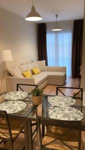 a living room with two tables and a couch at Apartamentos Poniente - Mares in Torre del Mar