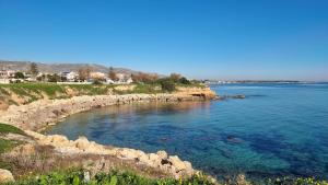 a view of a body of water with rocks at Casa Francesca in Avola