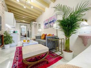 a living room with a couch and a table at Juderia de Sevilla VI Luxury Apartments in Seville