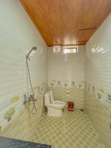 a bathroom with a toilet and a shower at Cosiana Homestay in Ninh Binh
